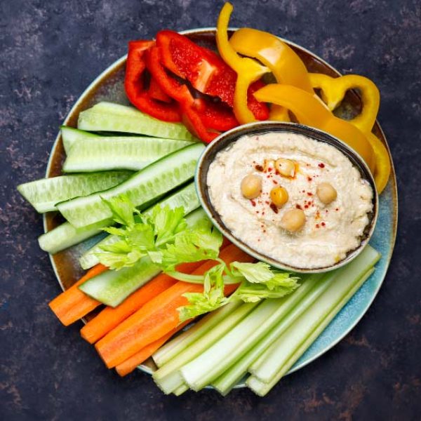 plate-fresh-organic-vegetables-salad-with-hummus-dark-brown-concrete-surface